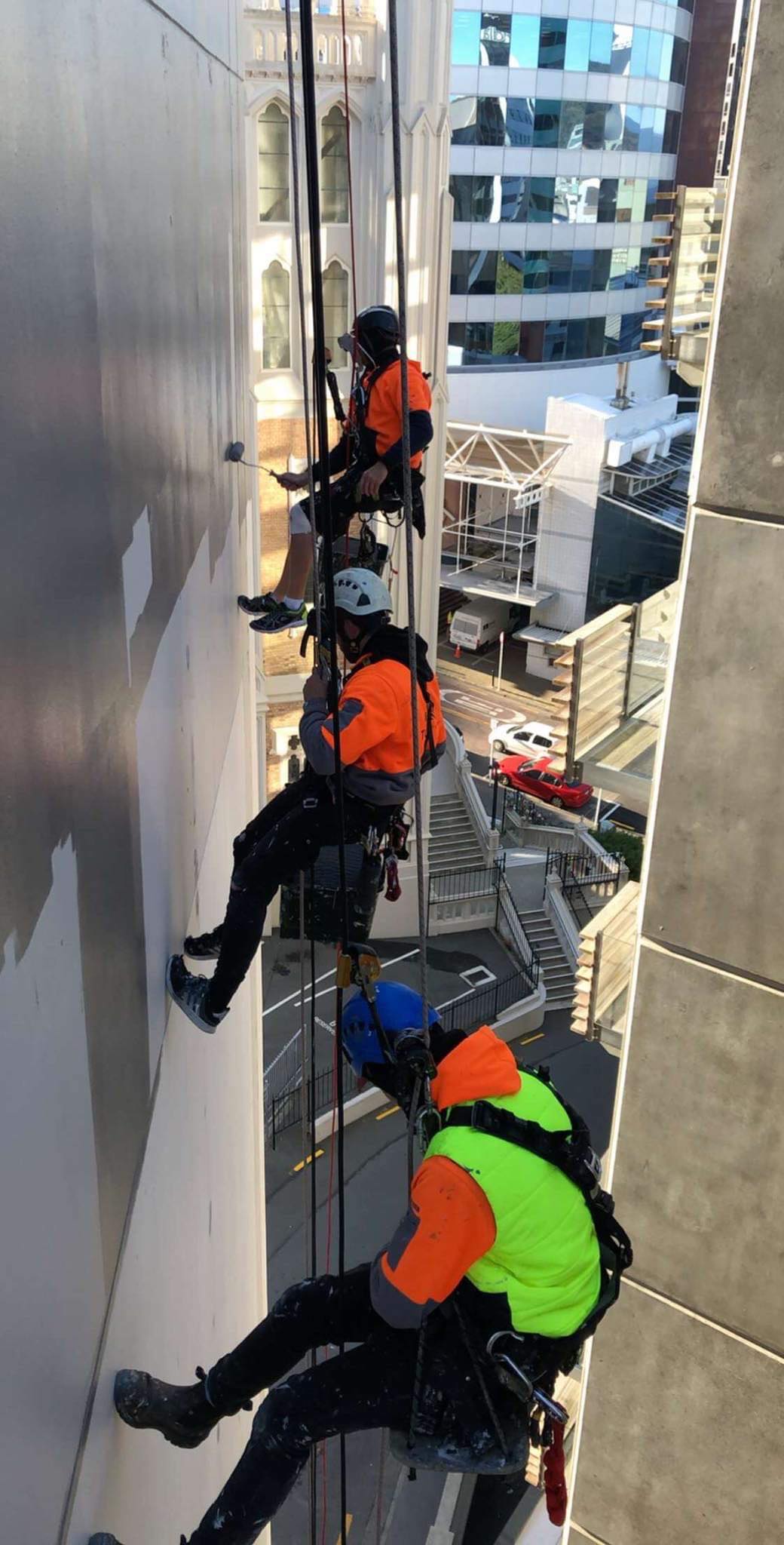 Painter applying fresh paint to a building exterior